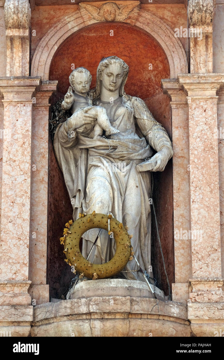 Virgin Mary with baby Jesus, statue on Piazza delle Erbe Market`s square in Verona, Italy Stock Photo